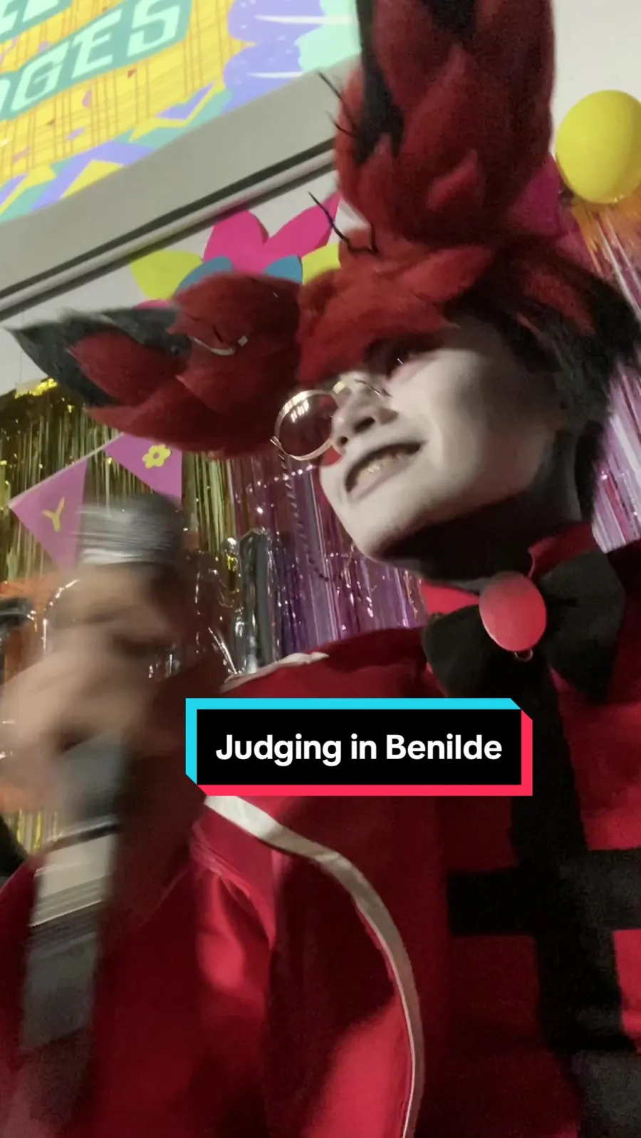 Kai Saga in Alastor cosplay judging the DrawINK Convention 2024 cosplay competition