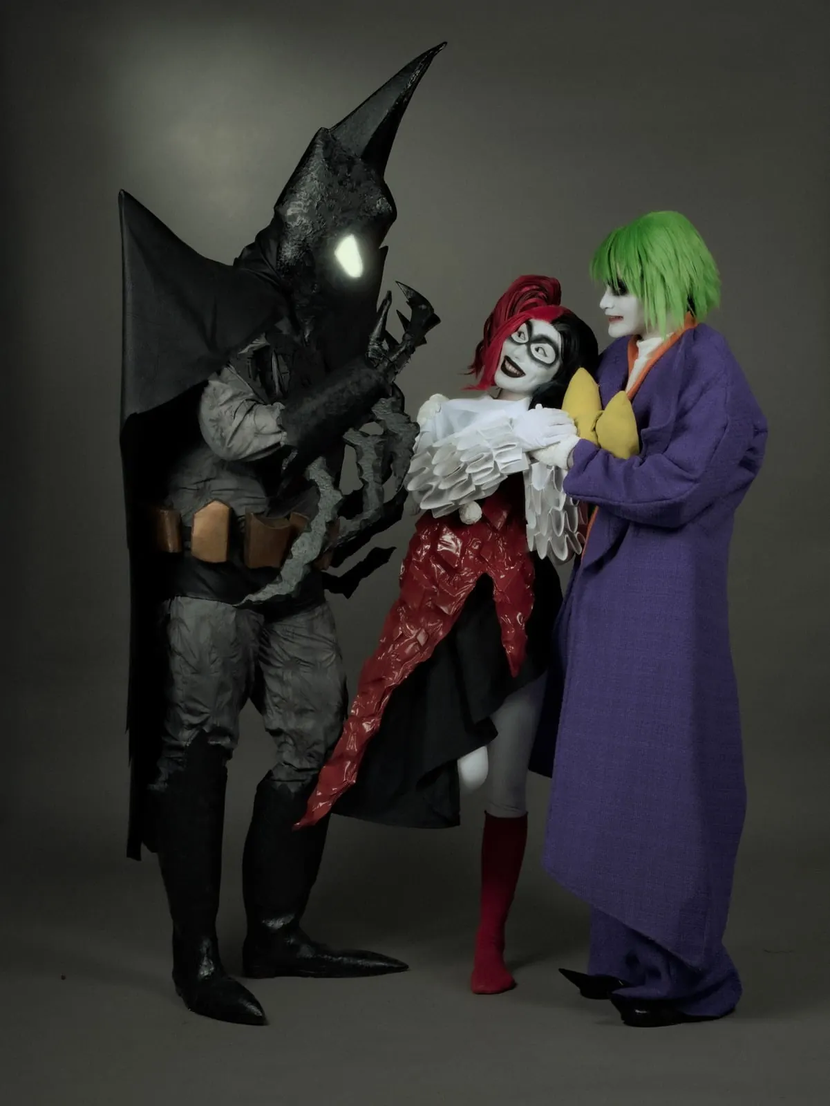 Ensemble villain group cosplay build — Batman, Harley Quinn and Joker costumes posed together